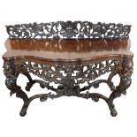 An 18th/19th Century continental shaped front console table with profusely carved floral and lion