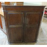 An Oak two door corner cupboard