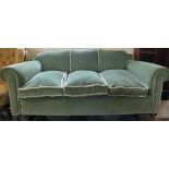 A green velvet three seater settee and two chairs