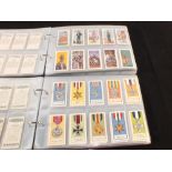 Seven albums of cigarette and trade card sets and part sets (some repro)