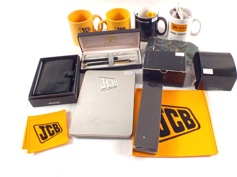 Various JCB promotional items including Parker pen, models,