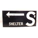 A painted metal sign 'Shelters with Arrow'
