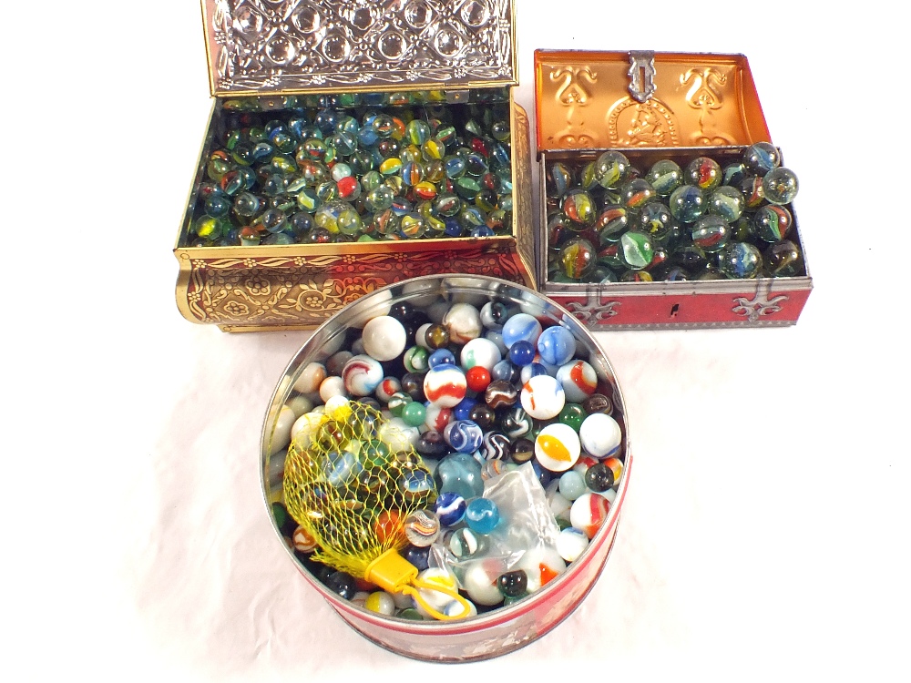 Three tins of various marbles