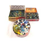 Three tins of various marbles