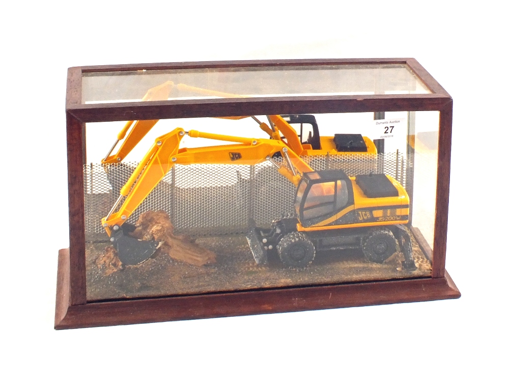 A glazed case containing JCB J5 200W Diaroma