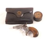 A Flobert starting pistol with an original tin containing some Eley Bros blanks and a vintage