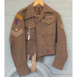 A 1945 dated blouse with insignia to Royal Armoured Corps and three medals, War medal,