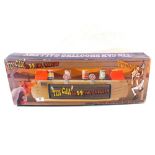 A boxed tin can shooting gallery game