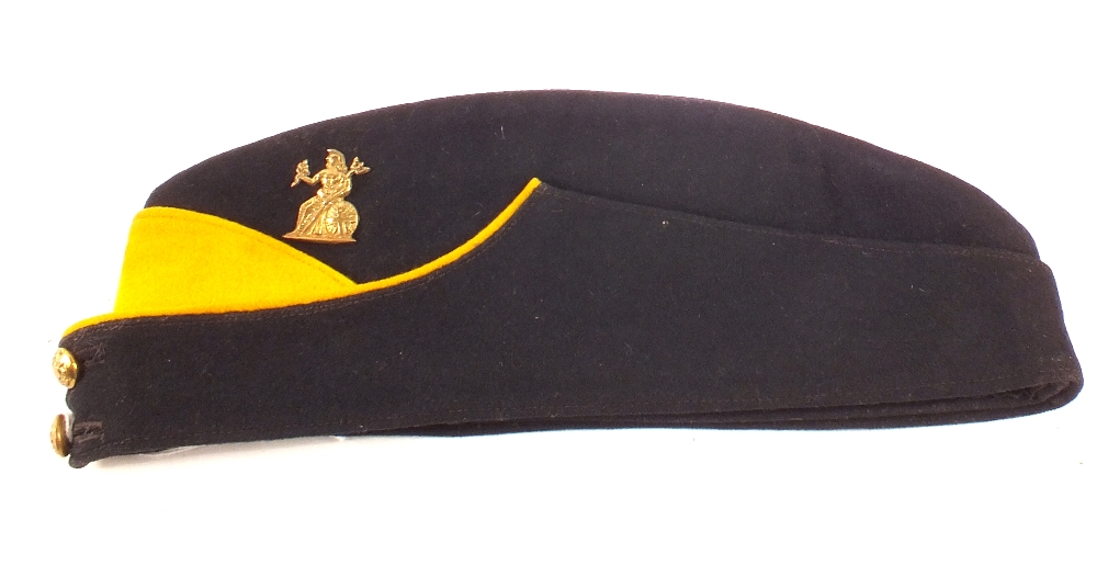 A Royal Norfolk Regiment field service side cap with yellow trim and badge