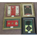 Four displays of military insignia including West Yorkshire and Sandhurst examples,