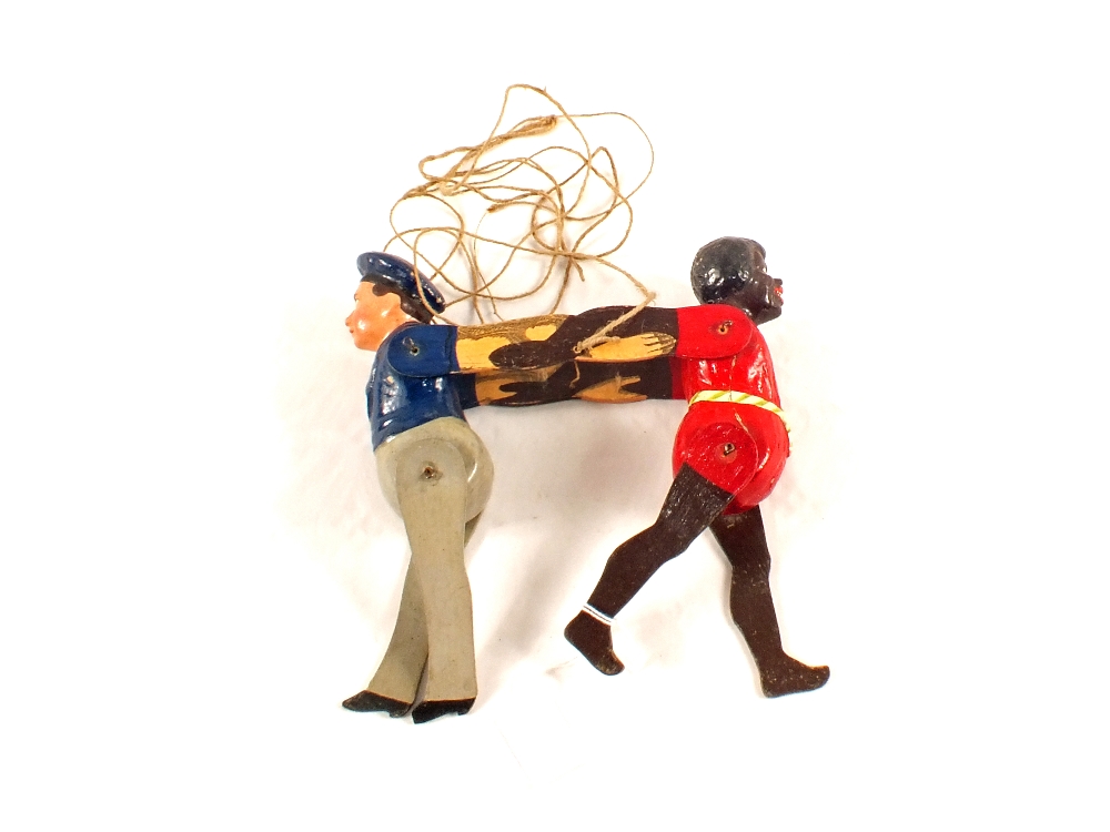 A painted wooden ethnic boy and sailor string puppet
