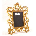 A gilt metal strut photo frame