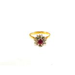 An 18ct Gold Ruby and Diamond set ring of flower form,