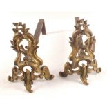 A pair of Rococo Brass and iron fire dogs