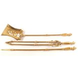 A decorative set of three heavy 19th Century Brass fire irons with knopped stems and pierced shovel,