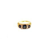 An 18ct Gold large three stone Sapphire ring set with small Diamonds inbetween (band misshapen)