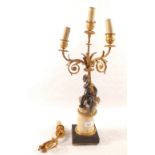 A four branch gilt metal lamp on metal cherub support on marble base (as found)