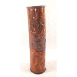 A tall Newlyn Copper spill vase of cylindrical form with repouse decoration of fish amongst seaweed,