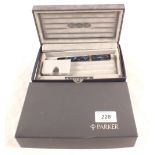 A boxed Parker blue mottled cartridge fountain pen