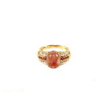 A 9ct Gold large pink cabochon stone set ring with Diamond set shoulders,