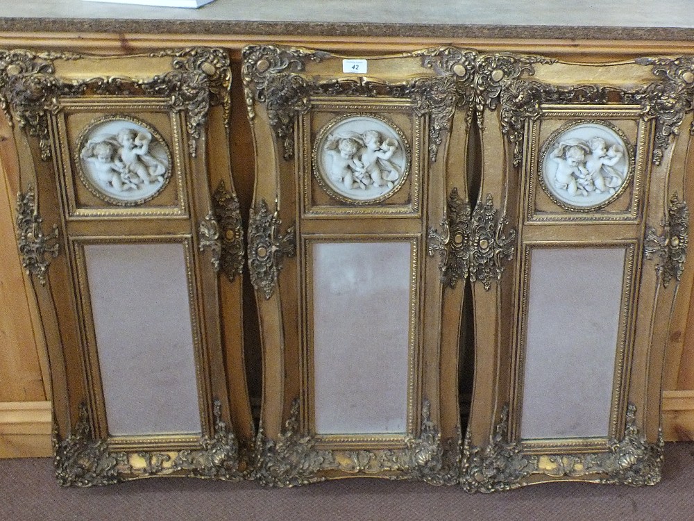 Three gilt mirrors with relief cherub decoration