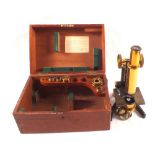 A Mahogany cased Brass and steel microscope and accessories by Swift & Sons,