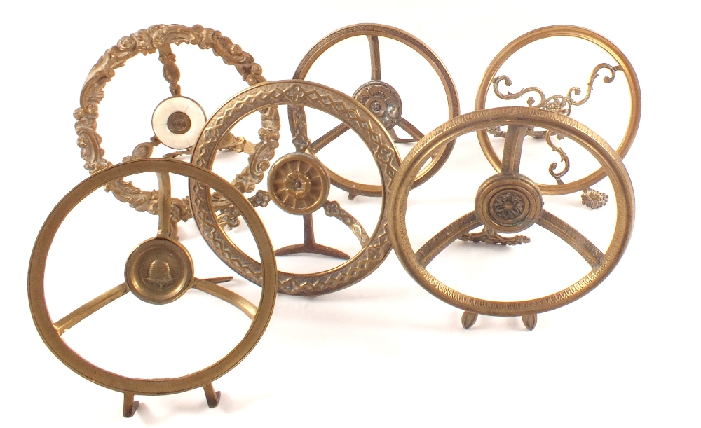 Six early 19th Century folding circular fire front Brass trivets,