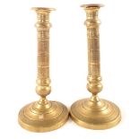 A pair of early 19th Century French seamed Brass candlesticks with engine milled decoration,