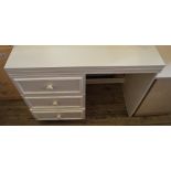 A modern cream chest of drawers with dressing table mirror,