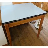 An extending folding top formica kitchen table