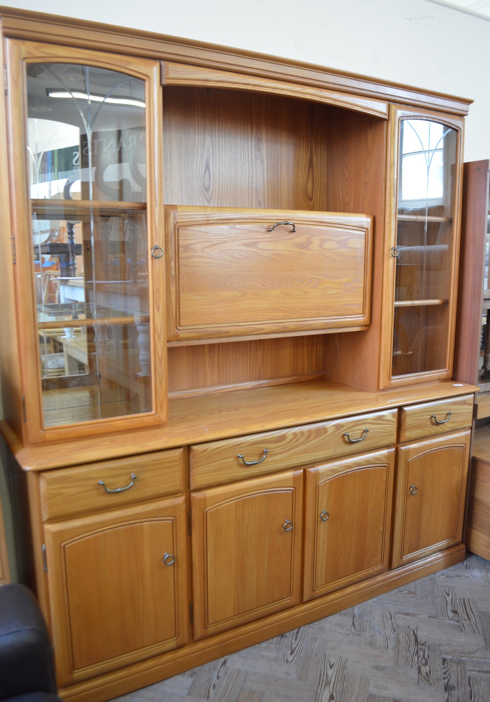 A Pine finish glazed and mirrored back wall unit