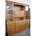 A Pine finish glazed and mirrored back wall unit