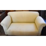 A cream upholstered two set settee