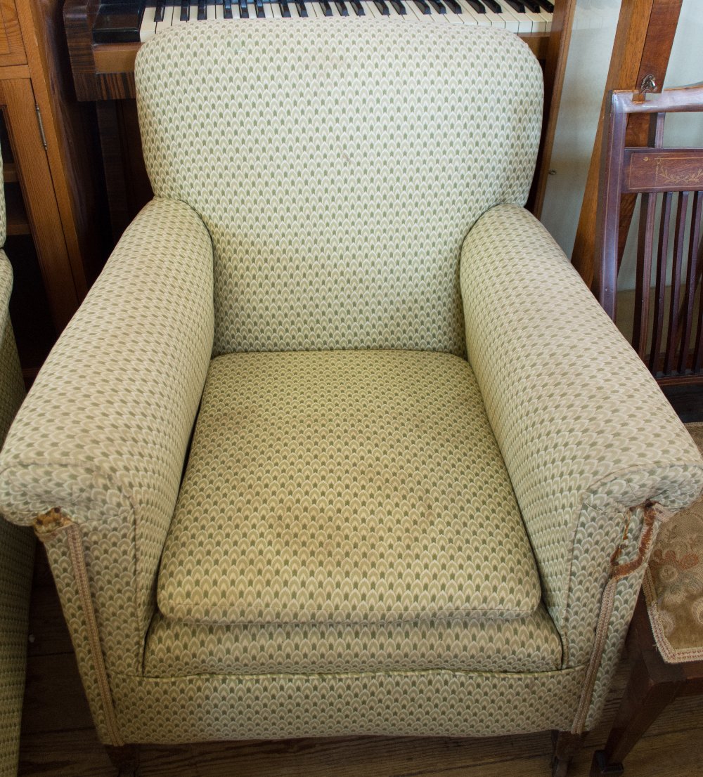 A pair of Edwardian green and cream upholstered armchairs