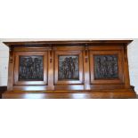 An Oak overmantel set with three Art Nouveau copper panels