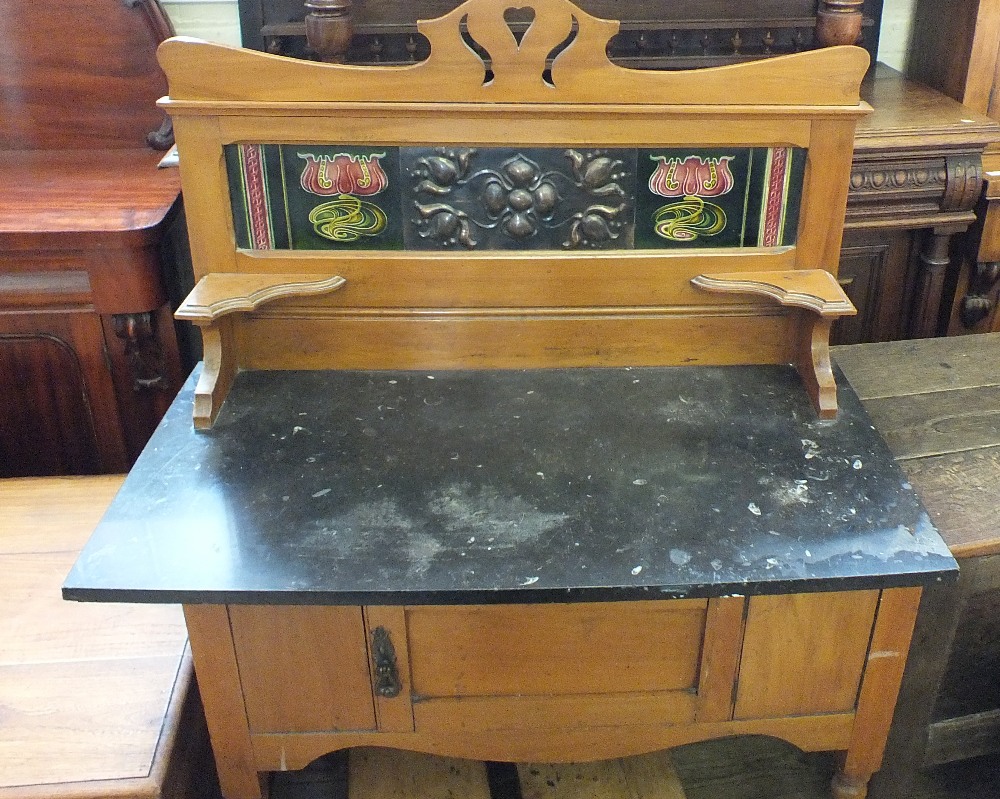 An Edwardian Satinwood and black marble washstand with Art Nouveau copper and tiled back