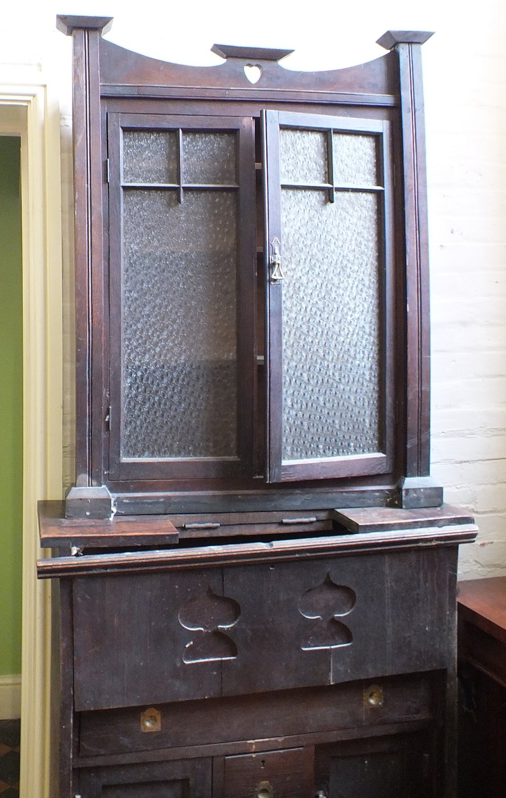 A glazed oak cupboard bookcase