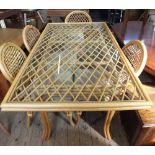 A modern cane conservatory dining suite, by Daro, comprising a glass top table,