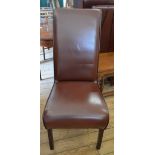 A set of four modern brown leather upholstered high back dining chairs