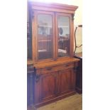 A Victorian Mahogany two door glazed cupboard bookcase