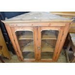 A Victorian glazed two door Pine hanging cupboard