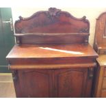 A Victorian carved Mahogany two door chiffoniere