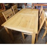 A modern rectangular dining table and four chairs