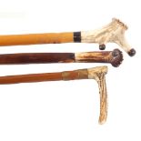 Two walking sticks with Deer Horn tops and a vintage riding crop