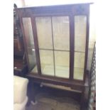 A Mahogany glazed single door china cabinet on table base