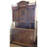 A 19th Century continental Oak sideboard of large proportions, with three cupboards,