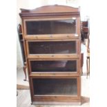An Oak four tier sectional bookcase marked "The Lebus Bookcase"