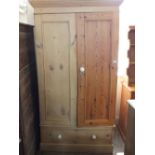 A Pine two door wardrobe with drawer below