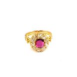 A continental Gold Ruby and Diamond set ring, central Ruby approx 1ct with Diamond set border,