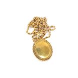 A yellow metal double photo locket on chain